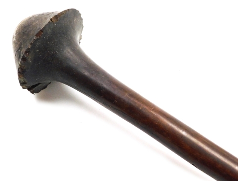 A 19thC New Caledonian Melanesia Kanak war club, of dense hardwood with a mushroom shaped phallic head, and a tapering cylindrical shaft, terminating in an expanded flange grip, 70cm wide. (AF)