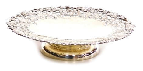 An Elizabeth II silver comport, with a moulded and pierced vine leaf and grape decorated border, Ollivant and Botsford Ltd, Sheffield 1960, 21.63oz, 27cm diameter.