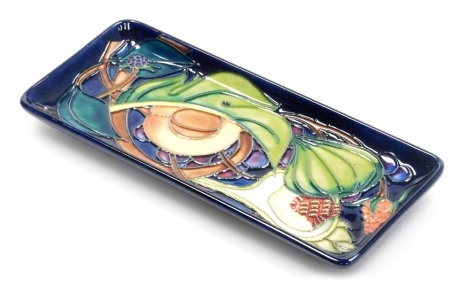 A Moorcroft pottery tray decorated in The Queens Choice pattern, of rectangular form, impressed and painted marks, 20cm x 8.5cm, boxed with outer slip case.