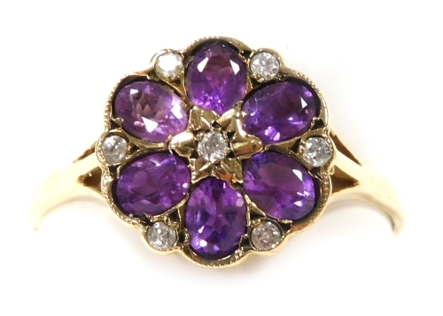 A 9ct gold amethyst and diamond flower head ring, in a six petal design, interspersed with diamonds at intervals, in a basket setting, size U, 2.1g.