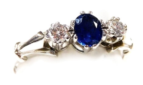 An 18ct white gold sapphire and diamond three stone ring, high claw set, diamonds approx 1/8ct, size N, 3.8g.