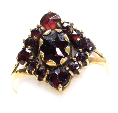 A late 19thC Continental garnet set ring, in an open work lozenge shape design, set in yellow metal, stamped 585, size P, 3.0g.