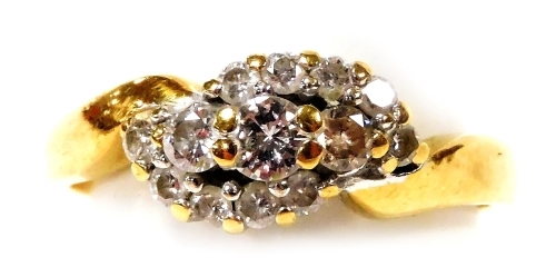 An 18ct gold and diamond ring, in a cross over style, size M, 3.4g.