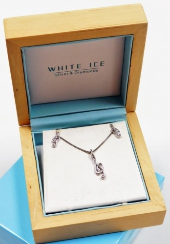 A White Ice silver and diamond set treble clef pendant necklace, and pair of stud earrings, boxed.