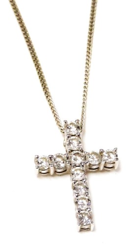 An 18ct white gold and diamond cross pendant, set with eleven diamonds, approx 1/3cts, on a fine curb link neck chain, with bolt ring clasp, 3.1g.