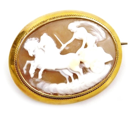 A late 19thC Continental shell cameo brooch, depicting Aurora driving a chariot, drawn by two horses, set in yellow metal, with pendant loop attachment, 7.4g all in.