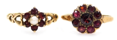 A 9ct gold and garnet flower head ring, size O, 2.1g, together with a 9ct gold garnet and seed pearl flower head ring, size Q, 1.5g. (2)