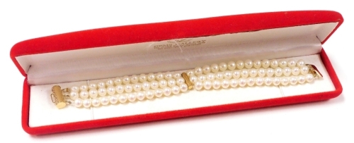 A cultured pearl three strand bracelet, on a yellow metal barrel and snap clasp, stamped 585, cased.