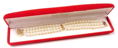 A cultured pearl three strand bracelet, on a yellow metal barrel and snap clasp, stamped 585, cased.