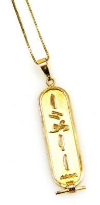 An Egyptian gold hieroglyphic pendant, with loop attachment, on a box link neck chain with a bolt ring clasp, in a bag for the Sheraton Hotel jewellery shop, 5.4g.