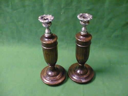 A pair of turned oak Candlesticks with plated sconces