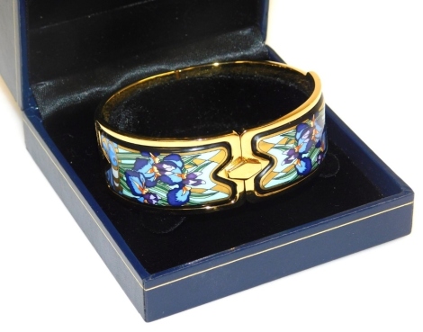 A Michaela Frey of Wien enamel set bangle, in yellow metal, decorated in the Art Nouveau style with irises, boxed.