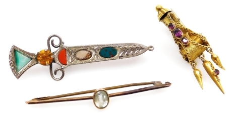 A Victorian aquamarine set bar brooch, in yellow metal, stamped 9ct, Victorian foiled metal earring, later converted to a brooch set with amethysts, and a Scottish silver and agate set dirk brooch. (3)