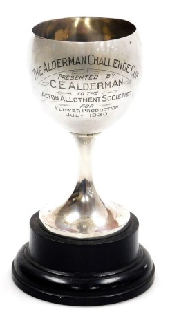 A George V silver trophy, presentation engraved 'The Alderman Cup, presented by C.E. Alderman to the Acton Allotment Society for flower production July 1930,' bearing winner's names and dates, Birmingham 1912, 4.31oz, 21.5cm high including hardwood stand.