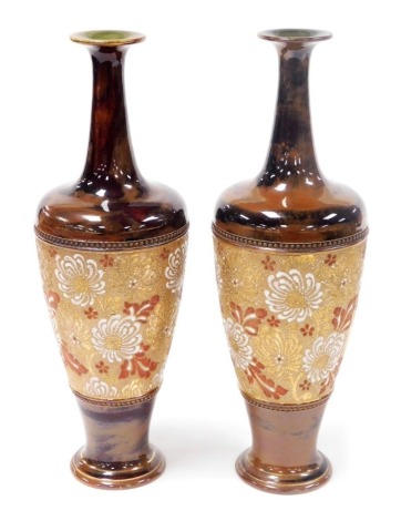 A pair of late 19thC Doulton Slater's pottery chine vases, of slender necked, baluster form, decorated with a central band of flowers, impressed marks, 39cm high.