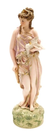 A 19thC Robinson and Leadbeater parian figure, of a lady in classical dress holding a bird, coloured and gilt heightened, printed marks, 35cm high.