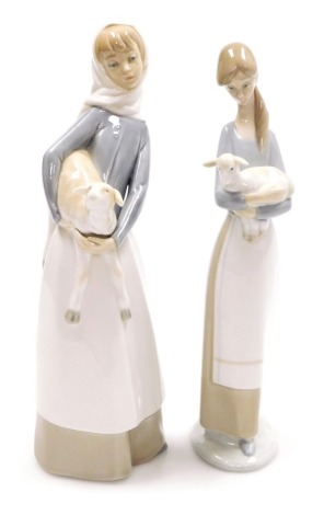 Two Lladro porcelain figures, comprising figure of a lady holding a sheep, 28cm high, and a further figure of a lady holding a lamb, 27cm high.
