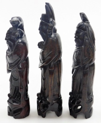 Three Chinese carved hardwood figures of the Sanxing deities, with silver wirework inlay, comprising Shou God of Longevity, 29cm high, Lu God of Prosperity, 33cm high, and Fu God of Fortune, 30cm high. - 2