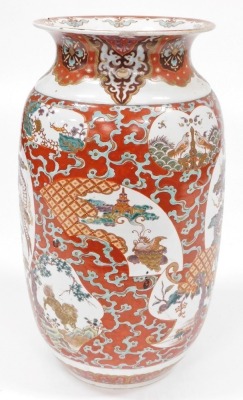 A Japanese Meiji period pottery vase, of cylindrical form with a flared rim, decorated with a reserve to front and verso of a three clawed dragon in clouds, further reserves of birds, trees, etc., on a red ground, 59cm high. (AF) - 2