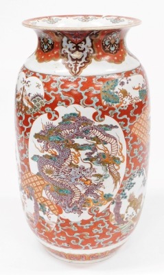 A Japanese Meiji period pottery vase, of cylindrical form with a flared rim, decorated with a reserve to front and verso of a three clawed dragon in clouds, further reserves of birds, trees, etc., on a red ground, 59cm high. (AF) - 3