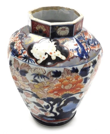 An 18thC Japanese Imari porcelain vase, of faceted baluster form, decorated profusely with flowers, panels of shishi, etc., 32.5cm high.