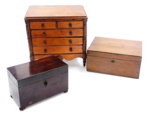 A Victorian mahogany apprentice chest, the top with a moulded cornice above two short and three long drawers, with a shaped apron, on turned legs, 26cm high, 26cm wide, 20cm deep, a 19thC flame mahogany twin division tea caddy, 19.5cm wide, together with 
