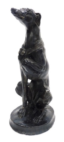 A 20thC painted composition sculpture of a Whippet, modelled seated wearing a collar, with one paw raised, signed to base D. S 1991, 52cm high.