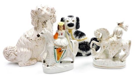 A group of 19thC Staffordshire style pottery, comprising two Spaniels, one painted, 38cm and 29cm high, and two figures of ladies on horseback, each 30cm high.