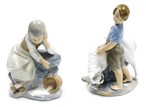 Two Nao porcelain figures, comprising a girl seated on a rock beside an upturned pail of milk, 19.5cm high, and a boy stood beside a ram, 22cm high.