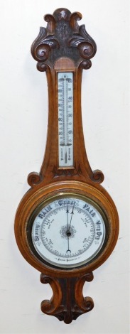 A Victorian oak cased aneroid barometer, with mercury Fahrenheit and centigrade measures, the case with carved scroll and leaf decoration, 93cm high.