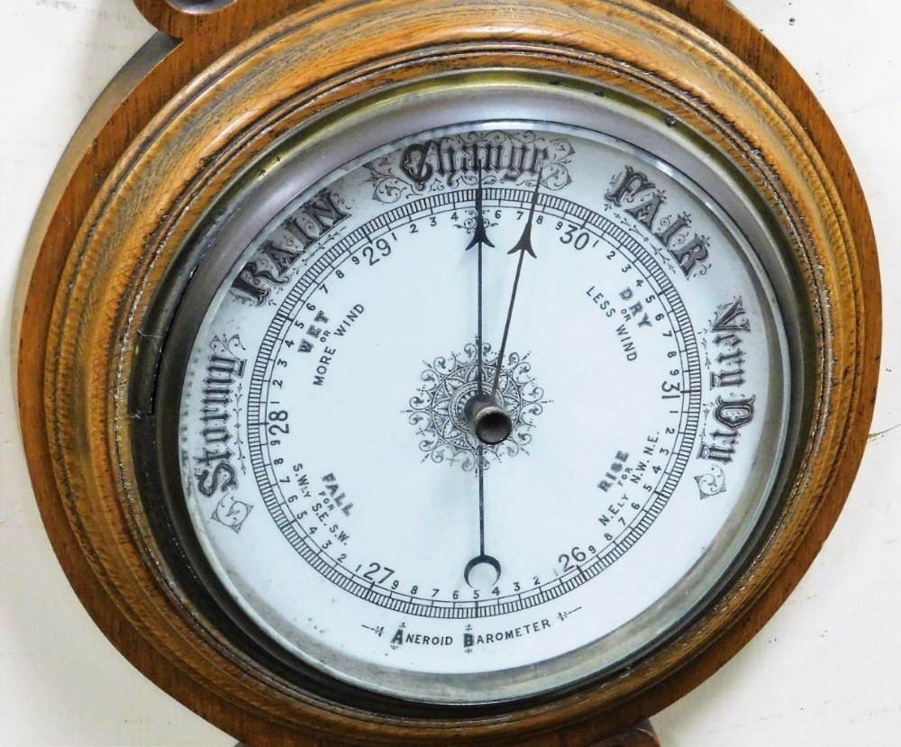 A Victorian oak cased aneroid barometer, with mercury Fahrenheit and