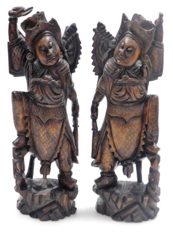 A pair of Balinese hardwood and silver wirework figures of the goddess Zhang Xian, each modelled with a baby in a papoose, 43cm high.