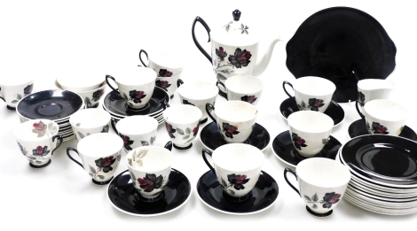 A Royal Albert porcelain Masquerade pattern part coffee and tea service, comprising coffee pot, two sugar bowls, twenty two saucers, eighteen cups, milk jug, twelve side plates, and a cake plate.