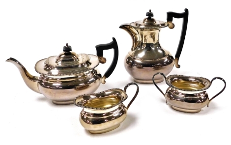 A Viners of Sheffield silver plated four piece tea set, with a gadrooned rim, comprising tea pot, hot water jug, cream jug, and sugar bowl.