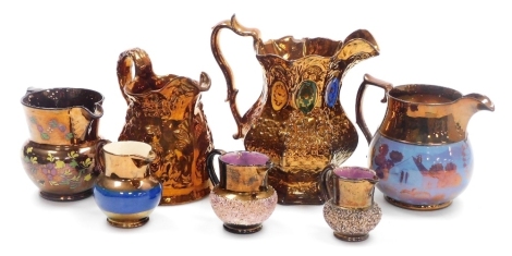 A group of Victorian copper lustre jugs, of varying sizes and designs, the largest 17cm high. (1 tray)