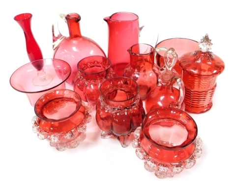 A group of Victorian and later cranberry coloured glass, to include cylindrical jar and cover, 18cm high, various jugs, etc. (1 tray)