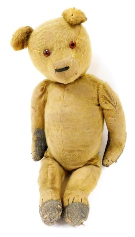 An early 20thC blonde coloured teddy bear, horse hair filled, approximately 60cm high.