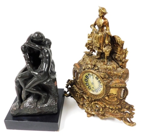 After Rodin. The Kiss, a bronzed plaster figure group produced by Alva Studios, stamped F. Barbedienne, on a square base, 30cm high, together with a 20thC German brass mantel clock, with Roman numeric dial, subsidiary seconds dial, key wind movement, the 