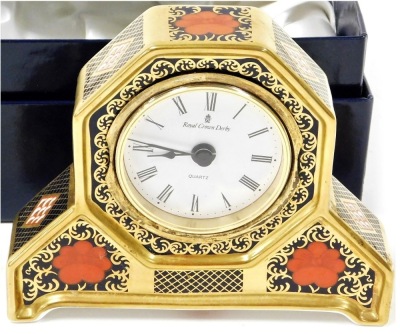 A Royal Crown Derby porcelain Old Imari pattern mantel clock, with a Roman numeric quartz dial, in a shaped case, 11cm high, boxed.