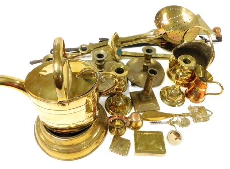 A group of brassware, to include a Victorian watering can, 22cm high, chamber sticks, fireside implements to include a poker, skillets, shoe horn, various candlesticks, trinket boxes, etc. (a quantity)