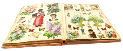 A Victorian and later scrap album, containing cut outs depicting flowers, animals, floral displays, Christmas scenes, etc.