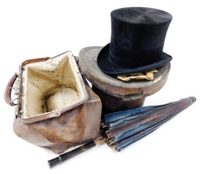 A Victorian moleskin top hat, contained in a leather hat box, the hat interior measurement 19cm x 15cm, an early 20thC leather Gladstone type bag, and a parasol.