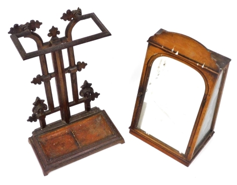 A Victorian cast iron umbrella stand, the back with fleur de lys type decoration, with rectangular drip tray, 51cm high, together with an oak tabletop display cabinet, with a raised shaped top above an arched mirrored door, enclosing a velvet lined interi