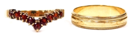 A 9ct gold and garnet wishbone ring, size P, together with a 9ct gold wedding band, size N, 4.3g.