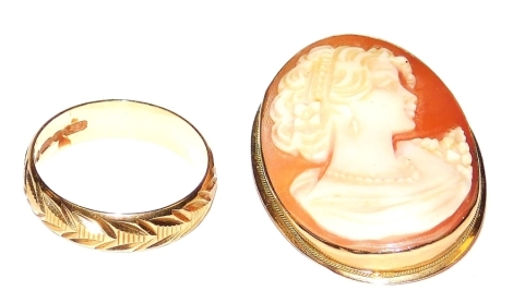 A 9ct gold wedding band, with engraved decoration, size P, 2.5g, together with an oval cameo brooch, bust portrait of a lady in a yellow metal mount, stamped 9k, 5.2g. (2)