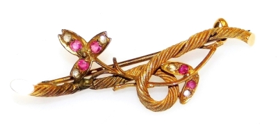 A Victorian ruby and diamond brooch, of scroll, branch and leaf form, set with old cut diamonds and rubies in a yellow metal setting, 3.1g.