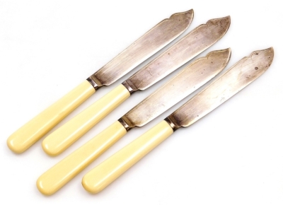 A group of four George V silver fish knives, with faux ivory handles, Sheffield 1933, 7.07oz all in.