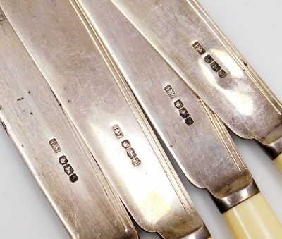 A group of four George V silver fish knives, with faux ivory handles, Sheffield 1933, 7.07oz all in. - 2