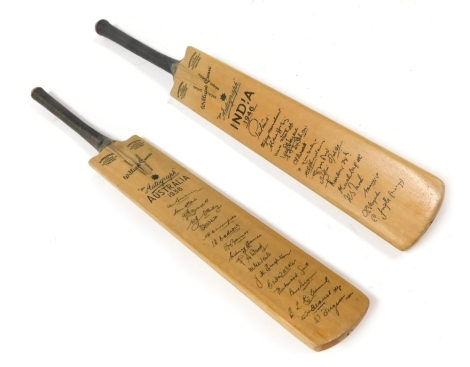 A pair of Gunn and Moore Ltd of Nottingham commemorative "The Autograph" cricket bats, commemorating Australia 1938, and India 1946, with facsimiles of the team's players, 29.5cm wide.