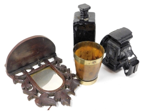 A group of collectables, comprising a horn beaker, with brass mounts, 10.5cm high, a dark brown glass bottle and stopper of square elongated form, 19cm high, a Milford bicycle lamp, 12cm high, and a carved wooden Black Forest style wall shelf, with mirror